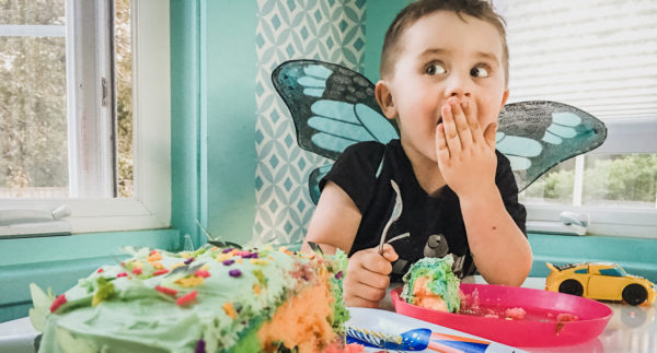 3-year-old boy eats birthday cake