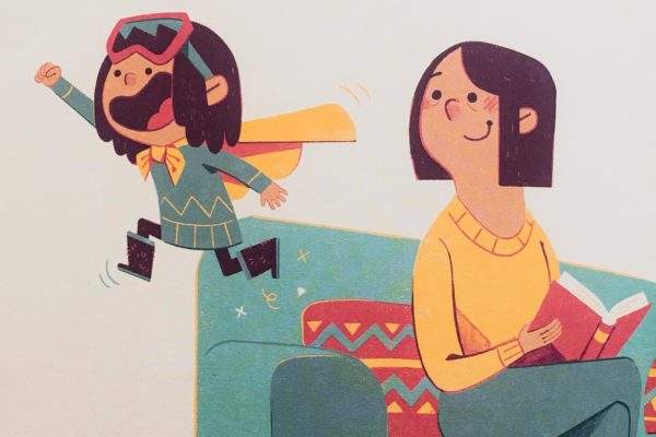 Little Nunavut girl with goggles & cape leaping off sofa as her smiling mother watches