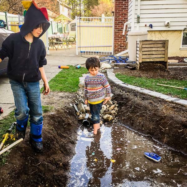kids play in freshly dug rain garden