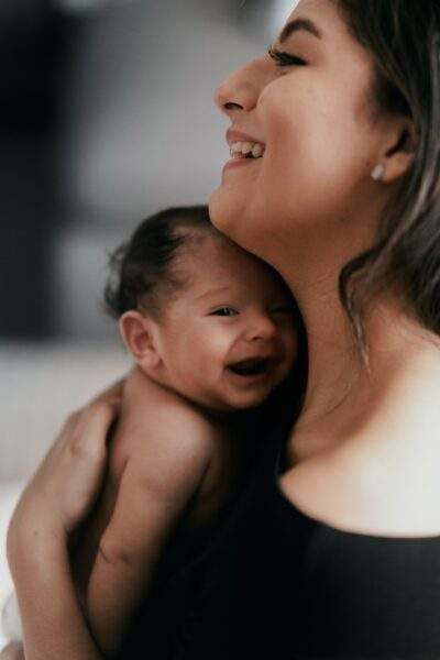 mother and infant smiling hug